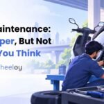 Mechanic repairing the brake and rear wheel of an electric scooter during a maintenance service